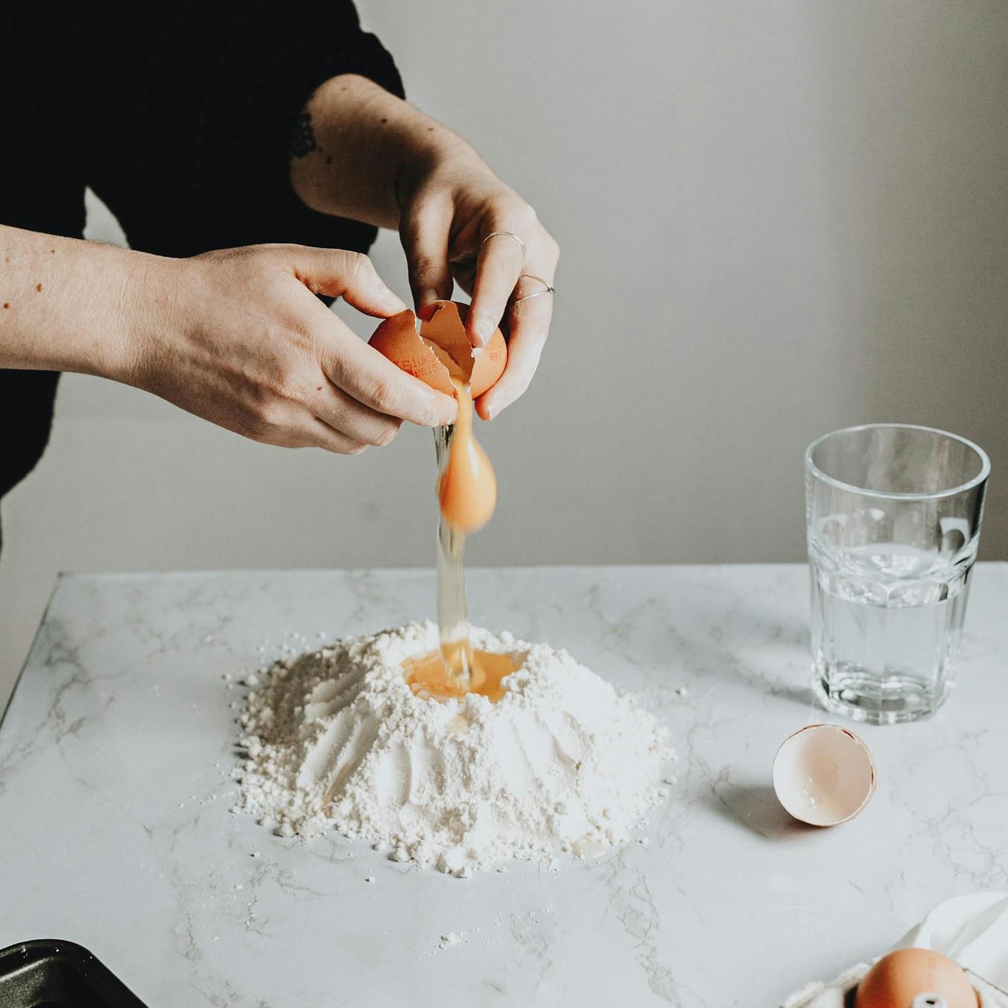 Community members collaborating in a modern kitchen space, sharing recipes and cooking techniques